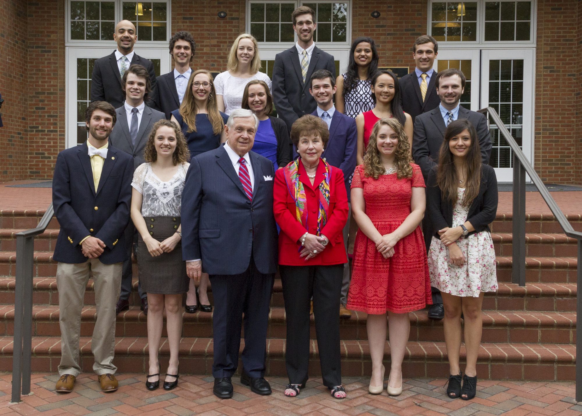 Sandra and Leon Levin standing with UNC Charlotte Levine Scholars at a Carolina Panther's game