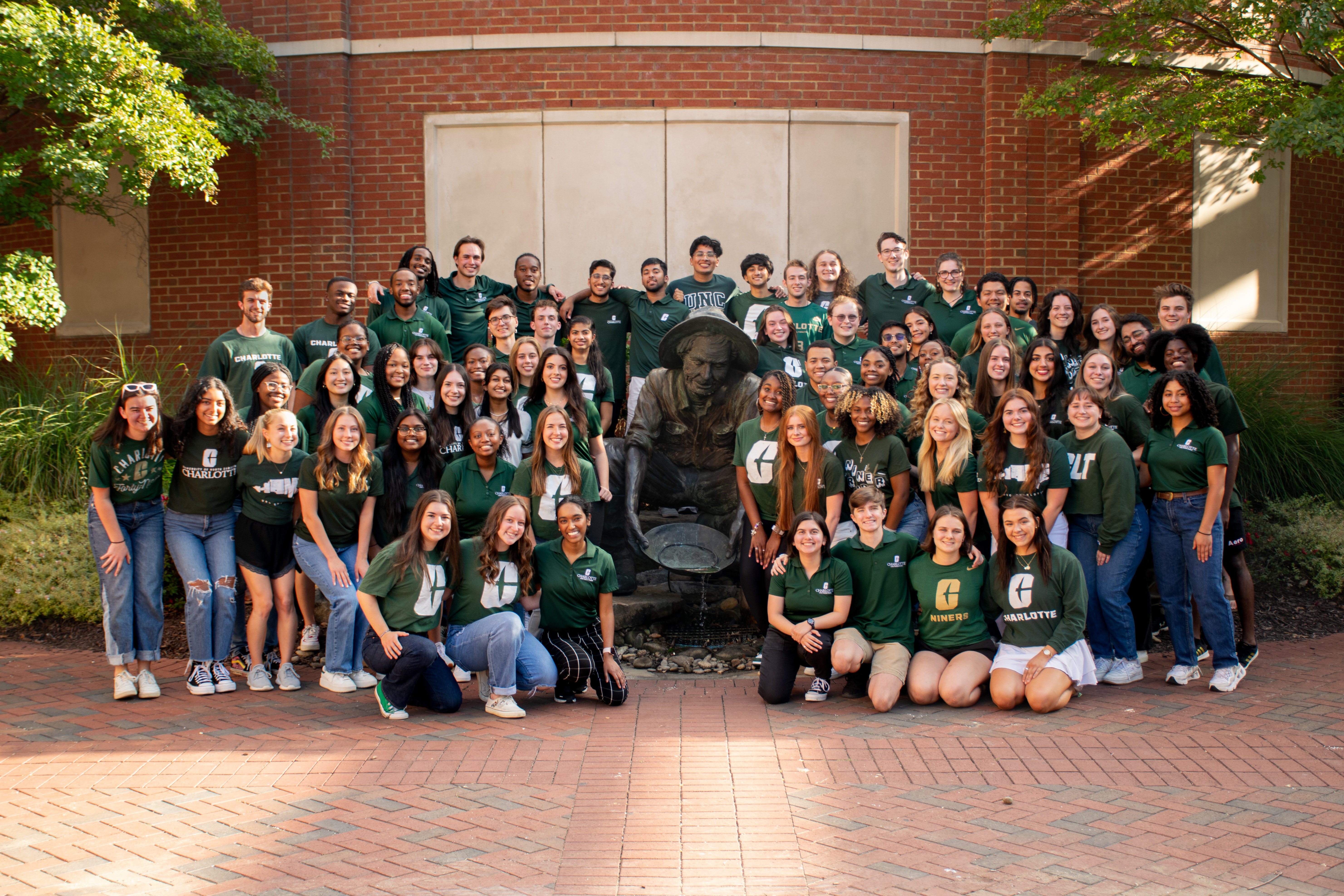 Levine Scholars Program portrait, fall 2023. Scholars pose with Norm the Miner.